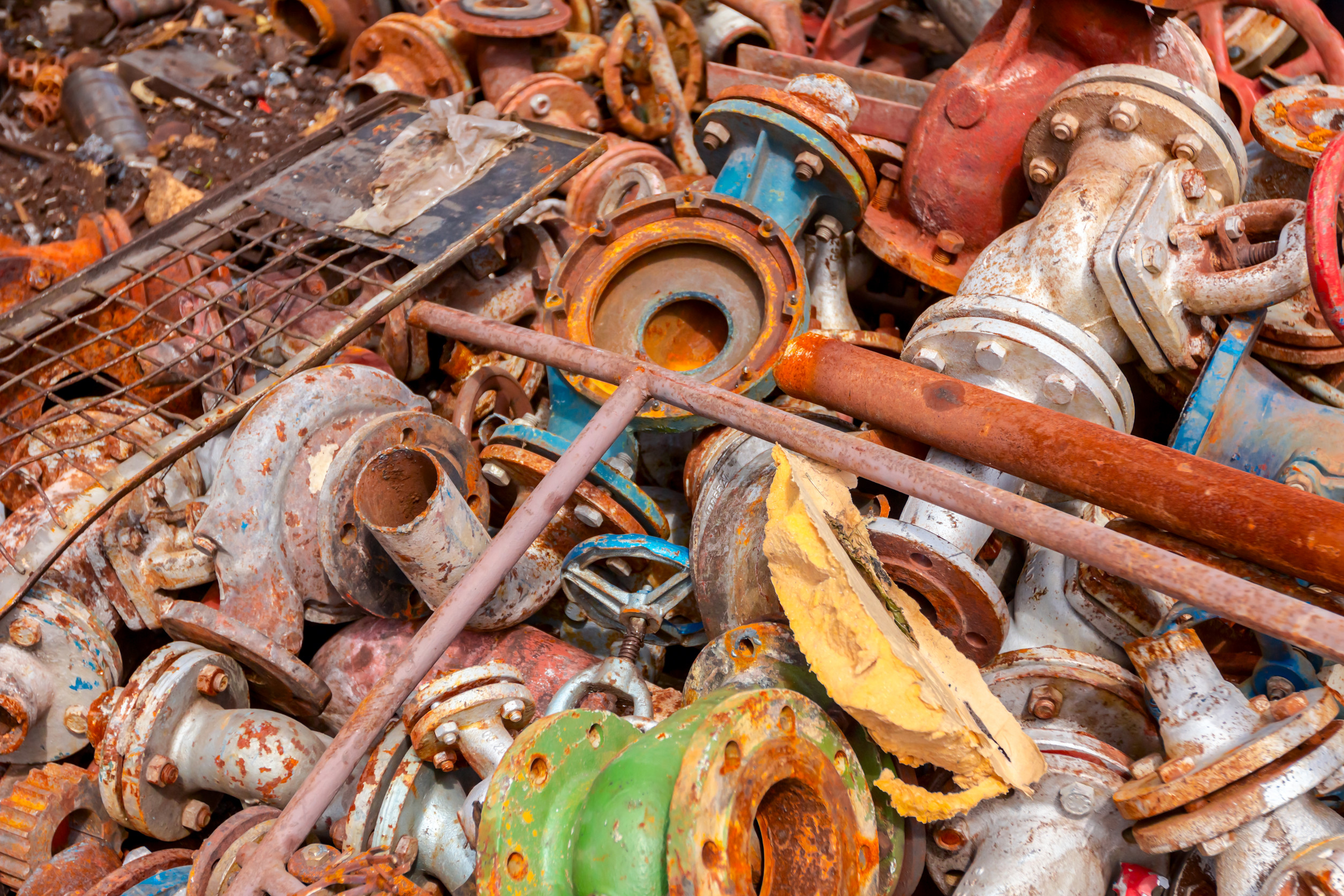 Various aged rusted parts of obsolete equipment at junkyard