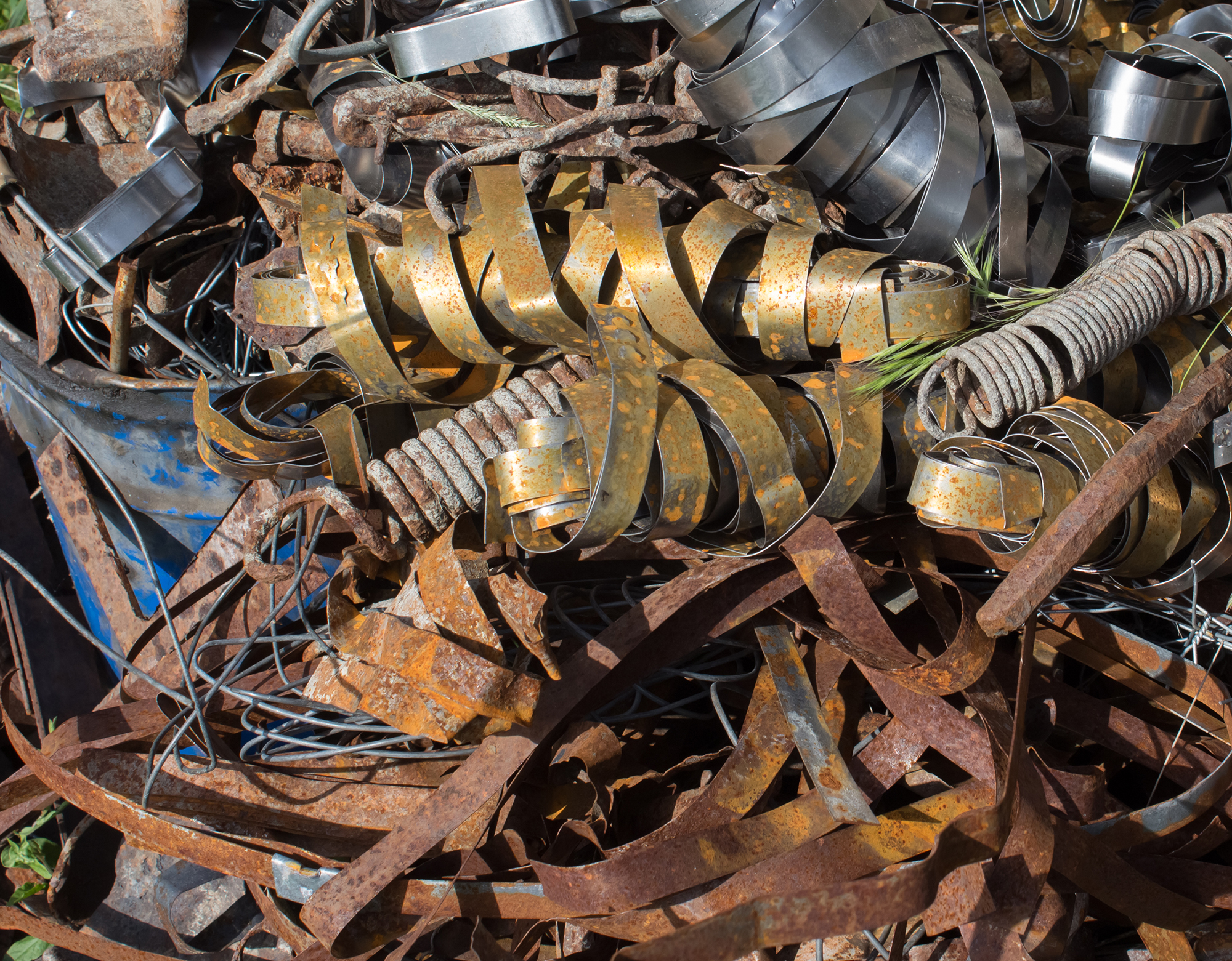 Pile scrap metal shavings isolated on white background. Scrap metal on recycling plant site.